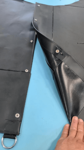 Black tarp used to encircle a mast and sealed with snaps