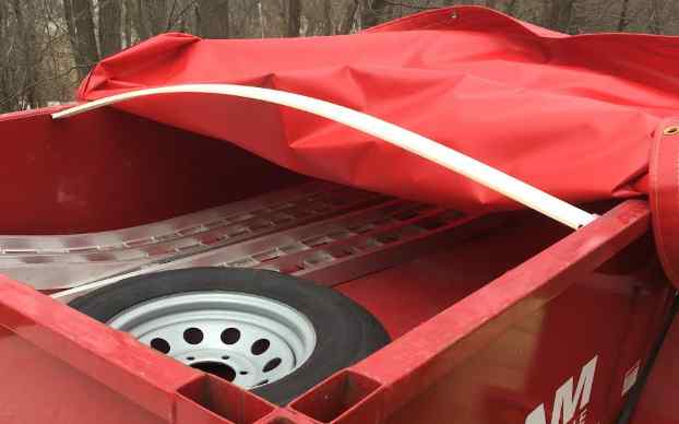 Red tarp on a trailer with bows