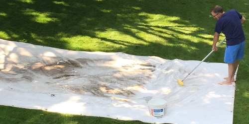 Tarp cleaning with a brush
