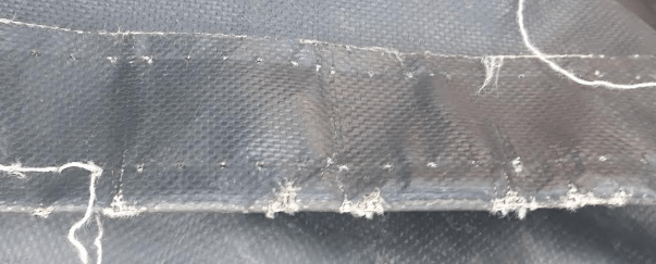 Worn tarp with torn stiching